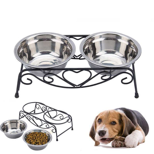 Double stainless steel pet bowl set with decorative black metal stand and a dog lying beside it
