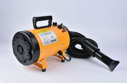 Pink metal dog hair dryer with black hose and four nozzle attachments on white background