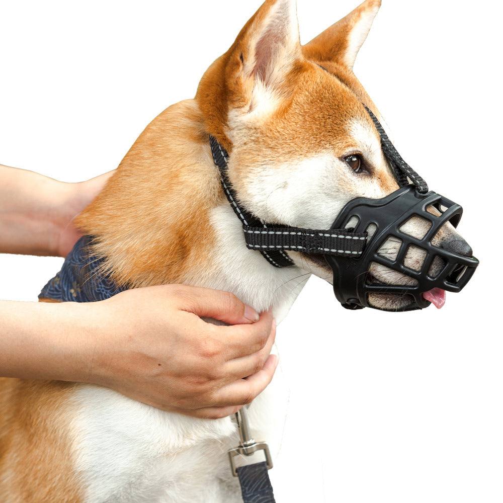 Adjustable black dog muzzle preventing biting, barking, and random eating on a brown and white dog