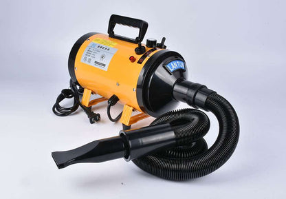 Pink metal dog hair dryer with black hose and four nozzle attachments on white background