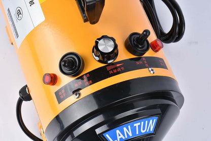 Pink metal dog hair dryer with black hose and four nozzle attachments on white background