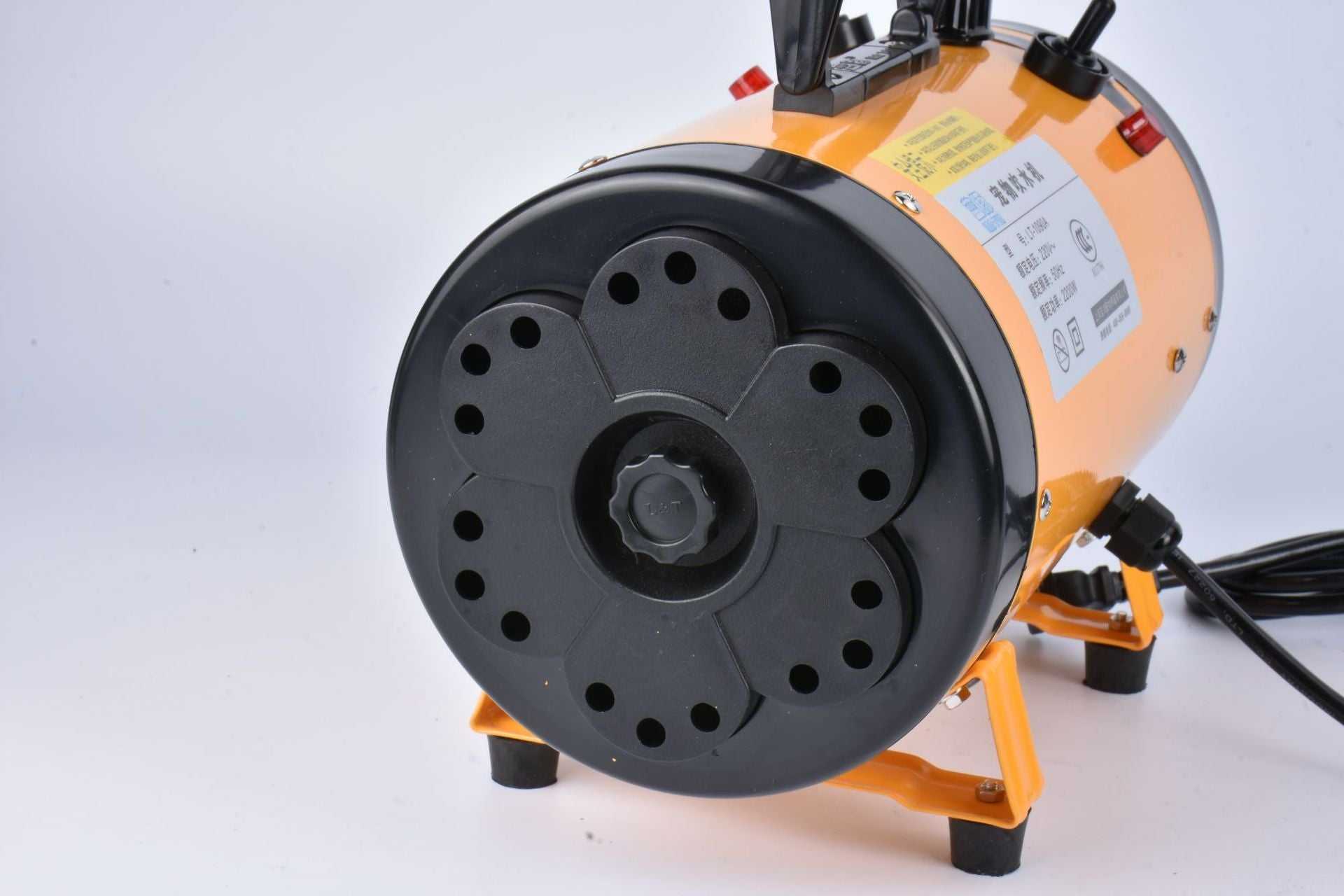 Pink metal dog hair dryer with black hose and four nozzle attachments on white background