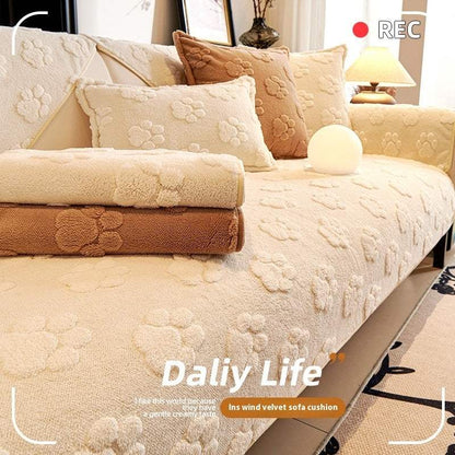 thickened fleece cream sofa cushion with embossed floral pattern and non-slip texture on a beige sofa